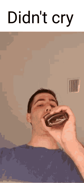 a man drinking from a bottle with the words did n't cry written above him