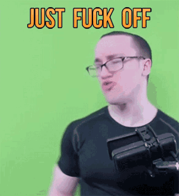 a man wearing glasses and a black shirt with the words just fuck off written above him