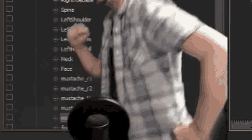 a man wearing a plaid shirt and tie is standing in front of a computer screen with a list of different parts of his body on it
