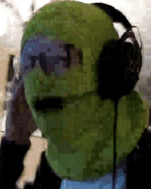 a pixelated image of a person wearing headphones and a green face mask