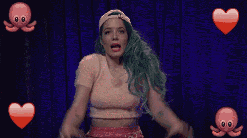 a woman with green hair is dancing on a stage with octopus and hearts .