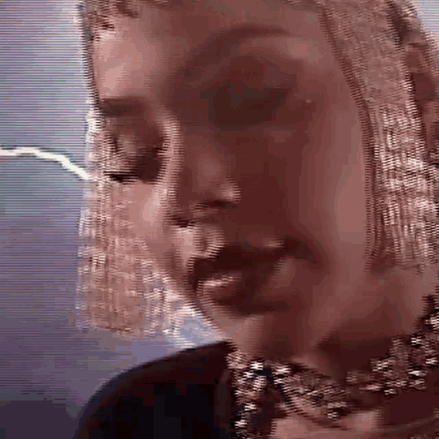 a close up of a woman 's face wearing a veil and a choker .