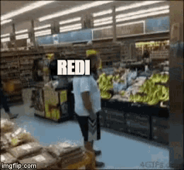 a man standing in a grocery store with the word " redi " on top