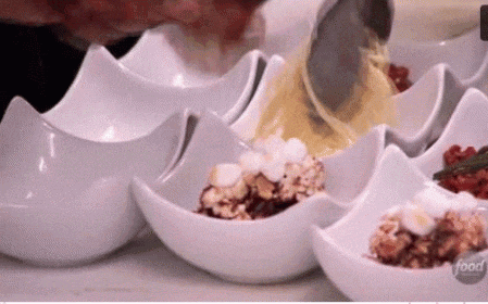 a person is pouring food into a bowl with the word food on it