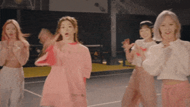 a group of young girls are dancing on a court