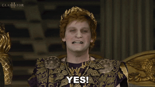 a man in a purple and gold outfit is smiling and says yes