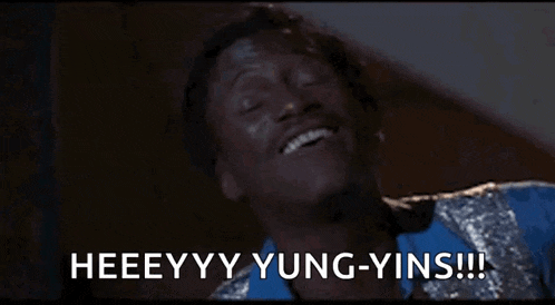 a man in a blue and silver suit is laughing and saying heeeyyy yung-yins