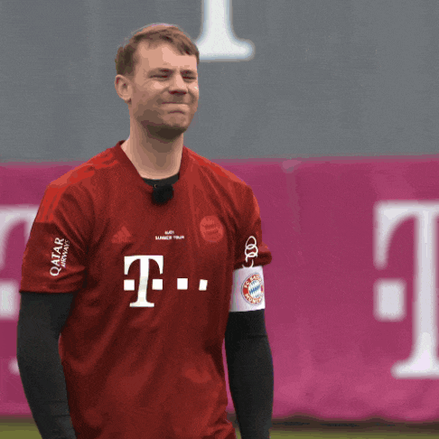 a man wearing a red t-mobile shirt makes a face