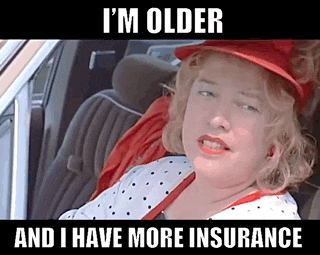 a woman in a red hat is sitting in a car with the caption i 'm older and i have more insurance .