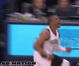 a basketball player is running in front of a screen that says sbnation on it