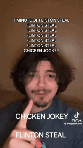 a man with a beard points to a chicken jokey flintton steal