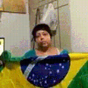 a woman is holding a large brazilian flag