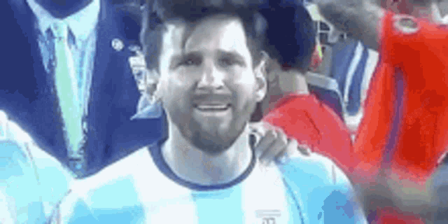 a close up of a soccer player wearing a blue and white striped shirt .