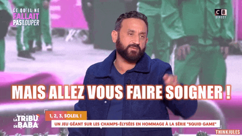 a man with a beard is talking on a tv show with the words mais allez vous faire soigner