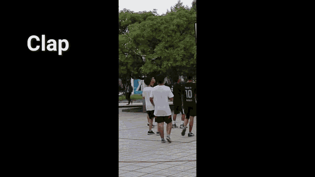 a man in a white shirt and black shorts is claping