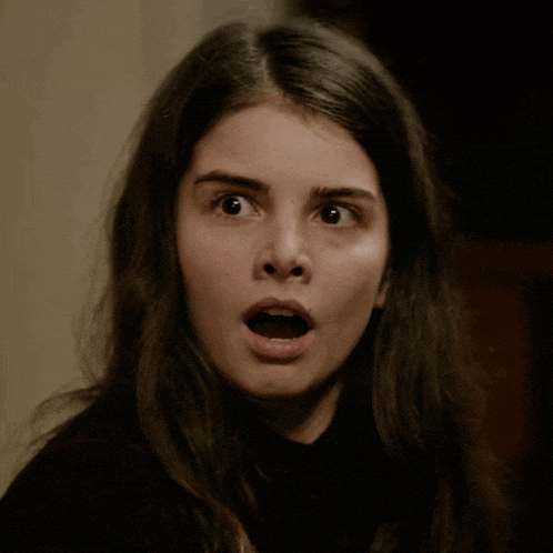 a close up of a woman with her mouth open