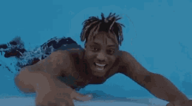 a man is doing a handstand in a pool .