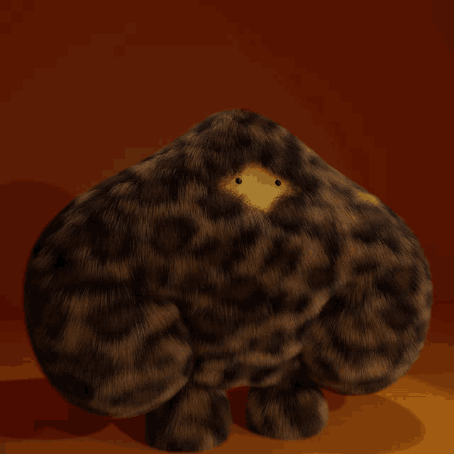 a stuffed animal with a yellow spot in the middle of it 's face