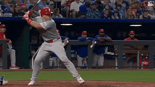 a baseball player is swinging his bat at a pitch in front of a crowd of people .
