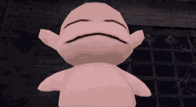 a pink stuffed animal with a sad face on it