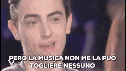 a close up of a young man 's face with a caption in a foreign language .