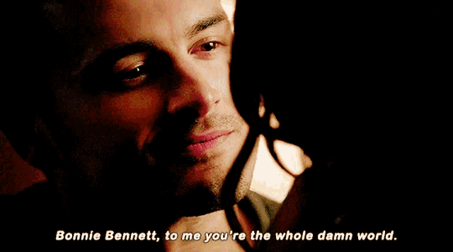 a close up of a man and woman with bonnie bennett to me you 're the whole damn world written below them