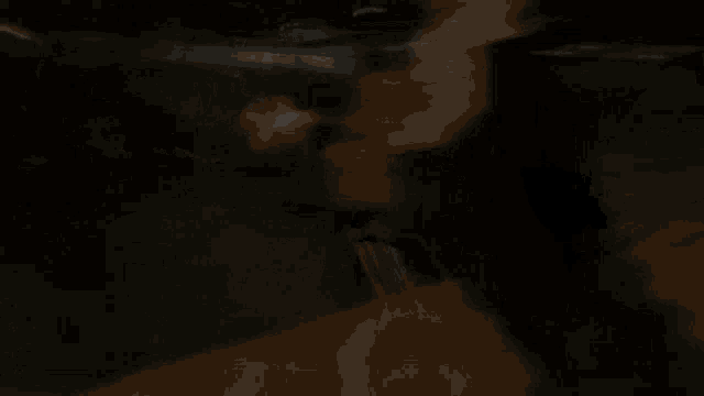a blurry picture of a person 's face in the dark .