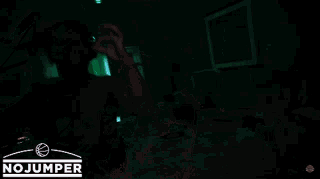 a man is wearing headphones and making a funny face in front of a no jumper logo