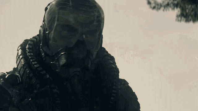 a man wearing a gas mask looks at something