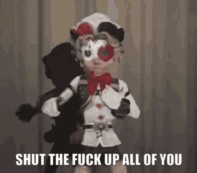 a cartoon character is standing in front of a curtain with the words `` shut the fuck up all of you '' on it .