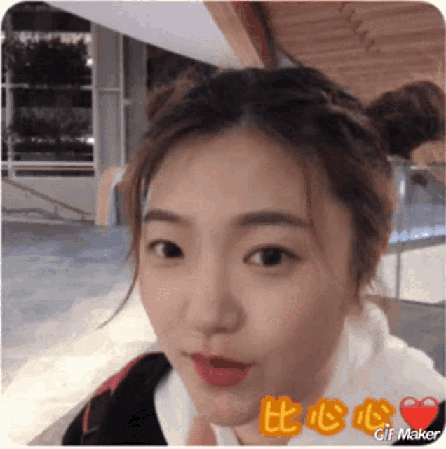 a close up of a woman 's face with the words gif maker on the bottom left