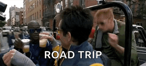 a group of men are sitting in a car drinking beer and talking .