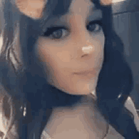 a close up of a woman 's face with a cat ear .