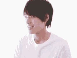 a young man is eating an apple and smiling .