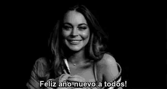 a black and white photo of a woman smiling with the words feliz ano nuevo a todos written below her .