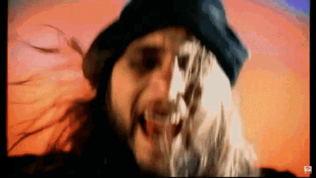 a close up of a person 's face with a hat on .