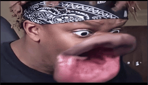 a man wearing a bandana and making a funny face with his mouth open .
