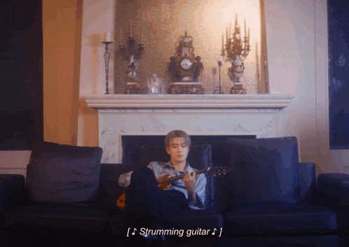 a man is sitting on a couch playing a guitar with the words " strumming guitar " below him