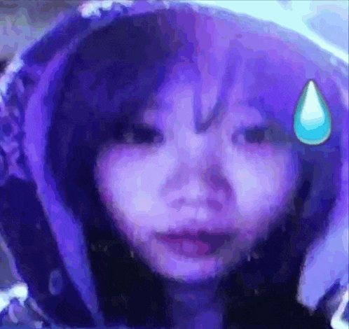 a girl with purple hair is wearing a purple hoodie and has a blue drop on her forehead .