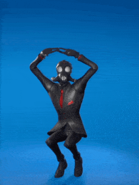 a man in a black suit and gas mask is dancing