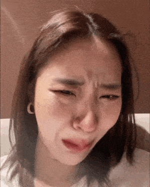 a close up of a woman making a funny face with her eyes closed