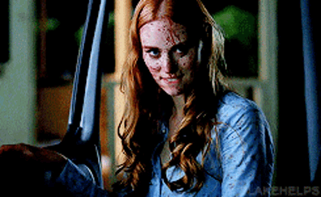a woman with red hair is holding a knife and the words lakehelps are visible in the corner