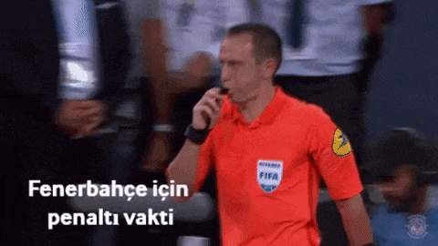 a referee wearing a red shirt that says fifa