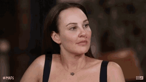 a woman wearing a black tank top and a necklace with # mafs written on the bottom