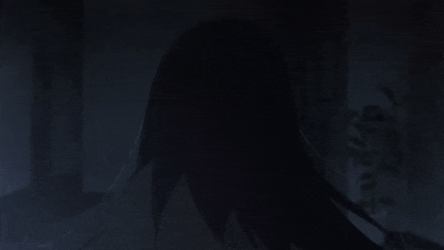 a girl with long black hair in a dark room