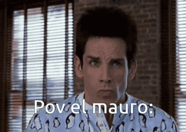 a man is wearing a pajama shirt with penguins on it and says " povel mauro "