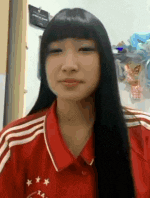 a girl with long black hair is wearing a red shirt