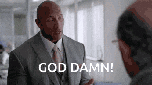 a bald man in a suit and tie is talking to another man in an office .