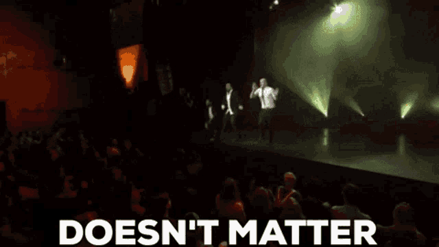 a group of people dancing on a stage with the words " doesn 't matter " written below them