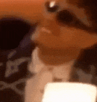 a close up of a person wearing sunglasses and a tie .